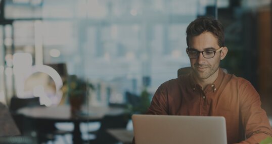 man working on notebook it jobs timetoact group